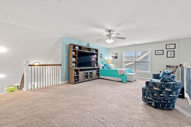 Living room featuring a ceiling fan and carpet | Image 23
