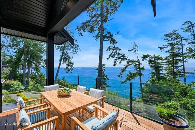 Wooden deck with a water view and outdoor dining space | Image 71
