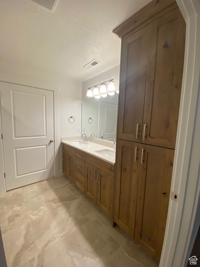Full bath featuring a sink, visible vents, and double vanity | Image 10