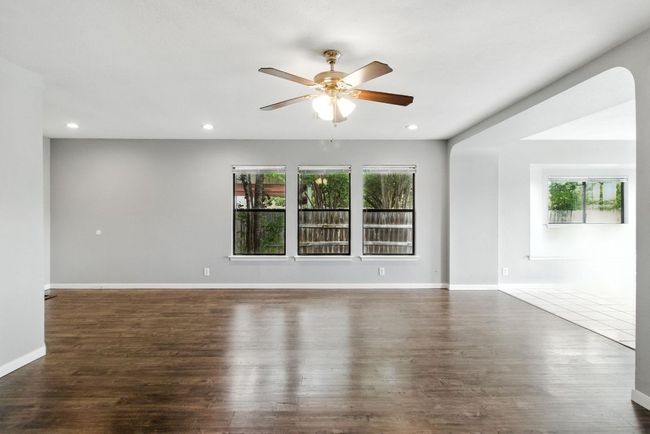 Living room has plenty of natural light from the windows and the recessed lighting. | Image 14