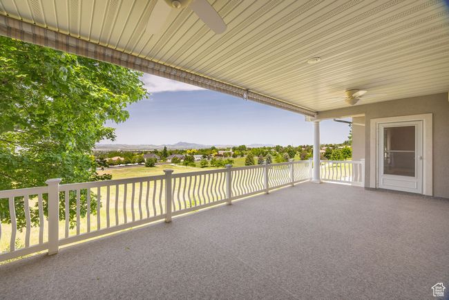 View of patio with a ceiling fan and a mountain view | Image 34