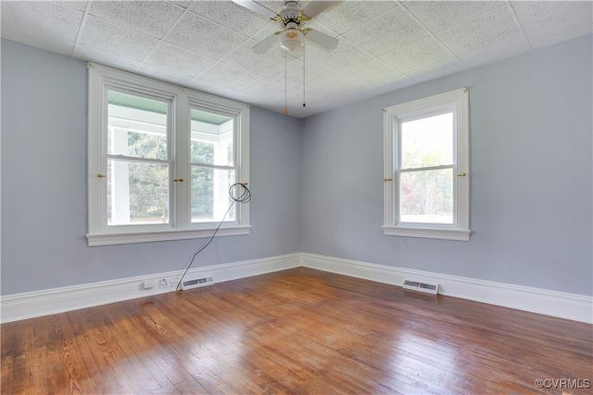 #1, w/large windows & hardwood wood floors, visible vents, and fan | Image 14