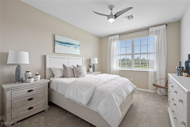 Carpeted bedroom featuring visible vents, baseboards, and a ceiling fan | Image 31