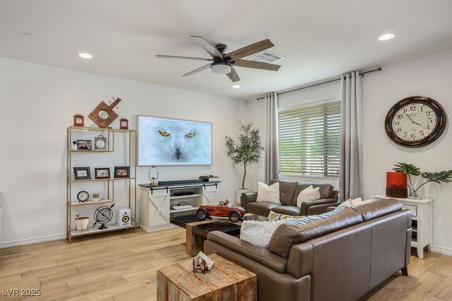 Living area featuring recessed lighting, light wood-style floors, baseboards, visible vents, and a ceiling fan | Image 10