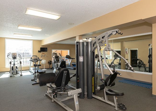 Exercise room featuring a textured ceiling | Image 21