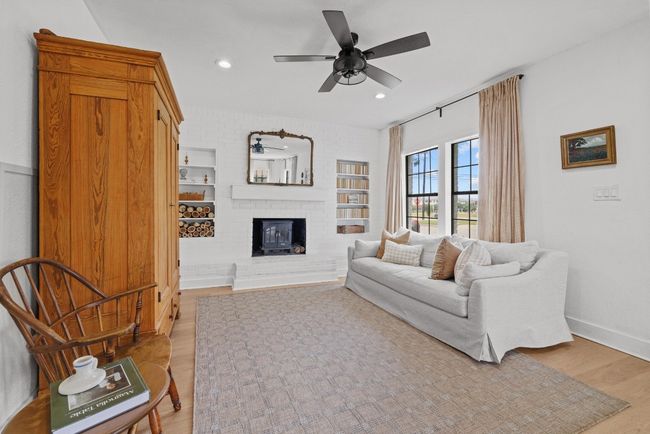 Living area featuring a brick fireplace, light wood-type flooring, ceiling fan, recessed lighting | Image 5