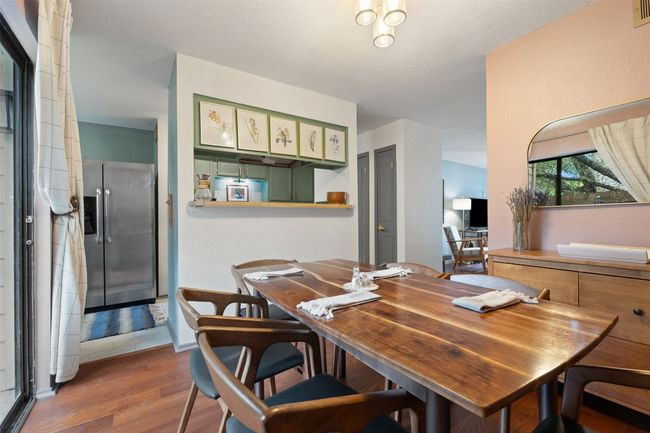 Dining area featuring visible vents and wood finished floors | Image 18