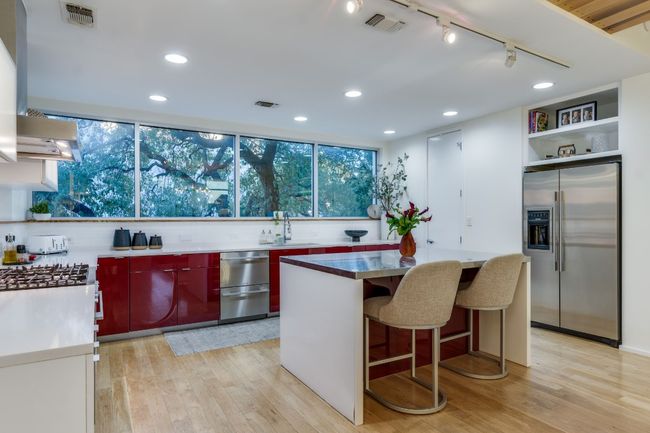 Kitchen with a kitchen breakfast bar, track lighting, a kitchen island, stainless steel fridge with ice dispenser, and light wood-type flooring | Image 14