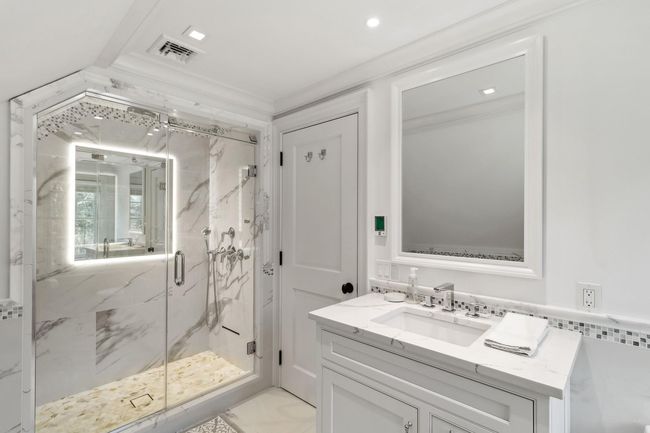 Bathroom featuring crown molding, vanity, and walk in shower | Image 38