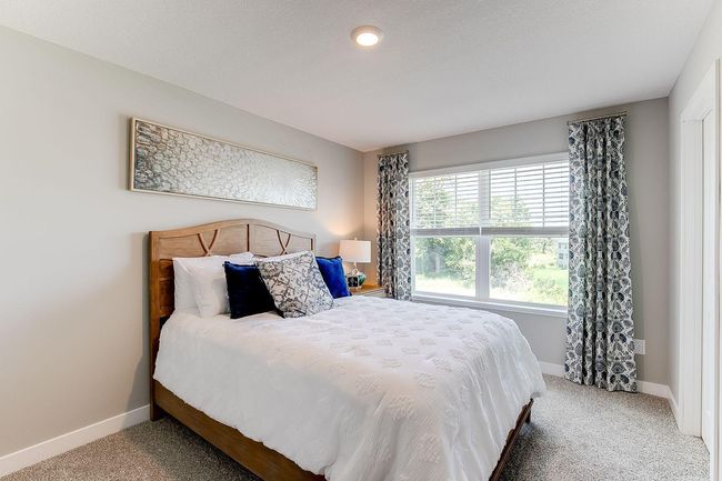 This bedroom, one of four upstairs features a walk-in closet. Photo of model home, color & options may vary. | Image 20