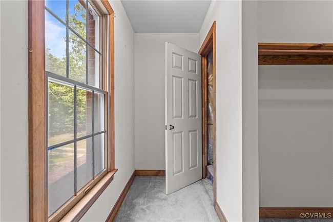 Hallway with light colored carpet and baseboards | Image 27