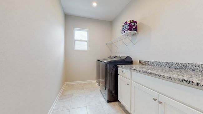 Huge laundry room upstairs with folding counter and cabinet space. Washer and Dryer included! | Image 38