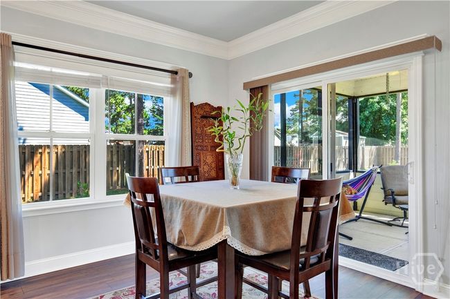 Lots of natural lighting fills this Breakfast room with sliding glass door onto the screened in patio. | Image 18