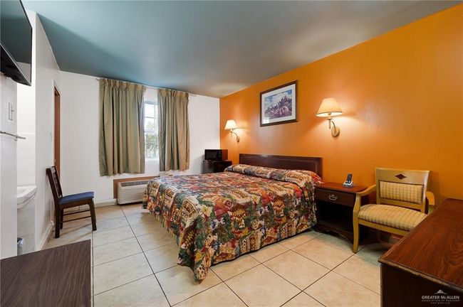 Bedroom with light tile patterned flooring and a wall mounted AC | Image 11