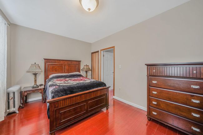 Bedroom with wood finished floors, and baseboards | Image 18