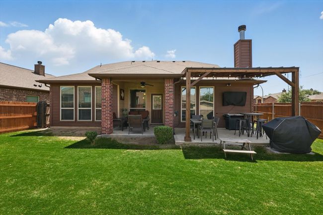 Back of property featuring a patio, a fenced backyard, and a lawn | Image 35