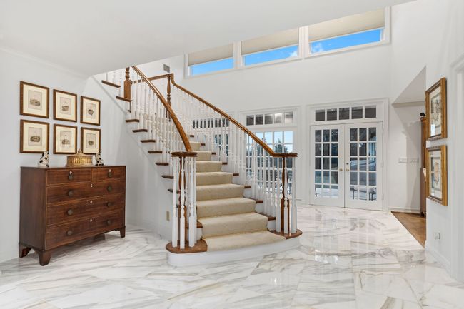 Marble floors frame curved staircase | Image 7