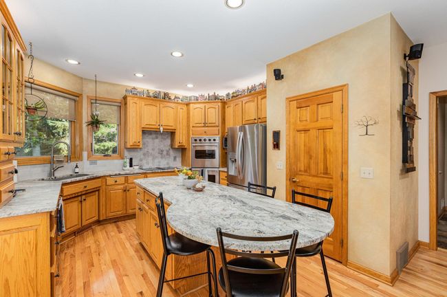 Large welcoming kitchen with breakfast bar - 9316 Yukon Ave S | Image 15