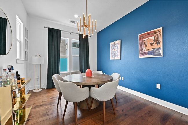 Dining room featuring a chandelier and hardwood / wood-style flooring | Image 5