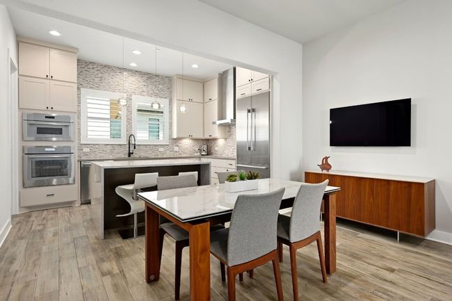 Kitchen opens to dining area. | Image 8