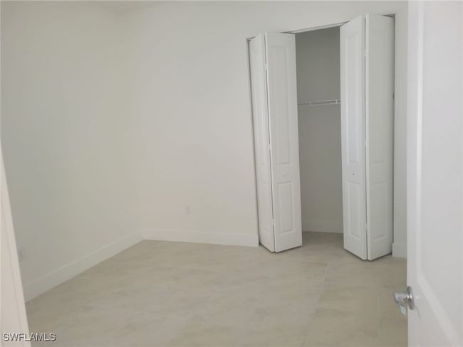 Unfurnished bedroom featuring baseboards and a closet | Image 25
