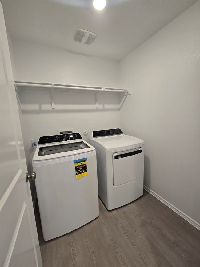 Laundry room with independent washer and dryer and wood finished floors | Image 21