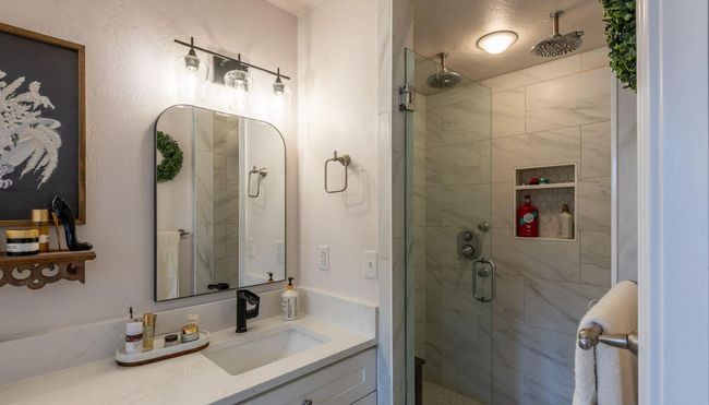Bathroom with a shower stall and vanity | Image 17