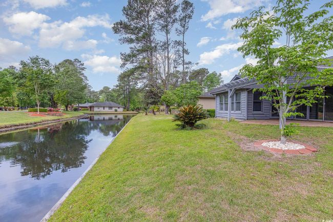 View of yard featuring a pergola and a water view | Image 31