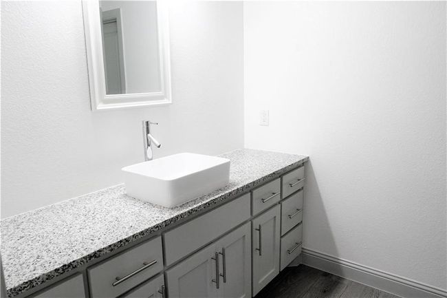 Bathroom with vanity, wood finished floors, and baseboards | Image 14