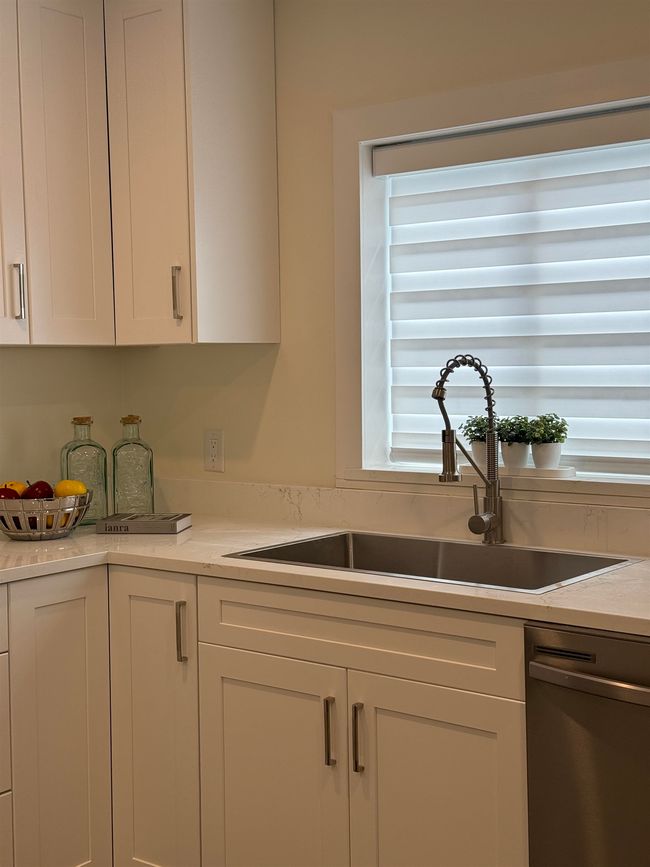 Kitchen with dishwasher, white cabinetry, and light countertops | Image 10
