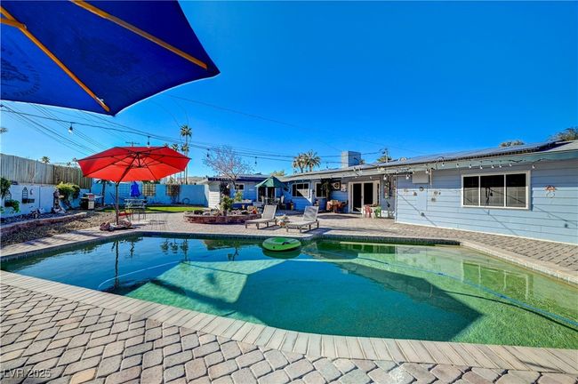 View of pool featuring a fenced backyard and a patio | Image 11