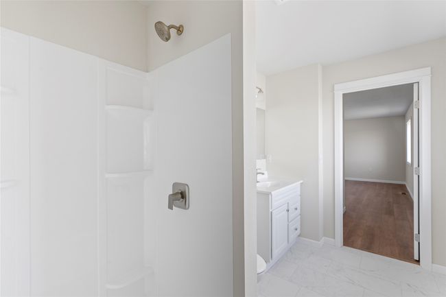 Full bathroom featuring vanity, marble finish floor, baseboards, and walk in shower | Image 49