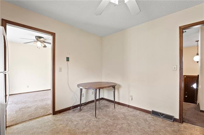 Carpeted empty room with a ceiling fan and baseboards | Image 14