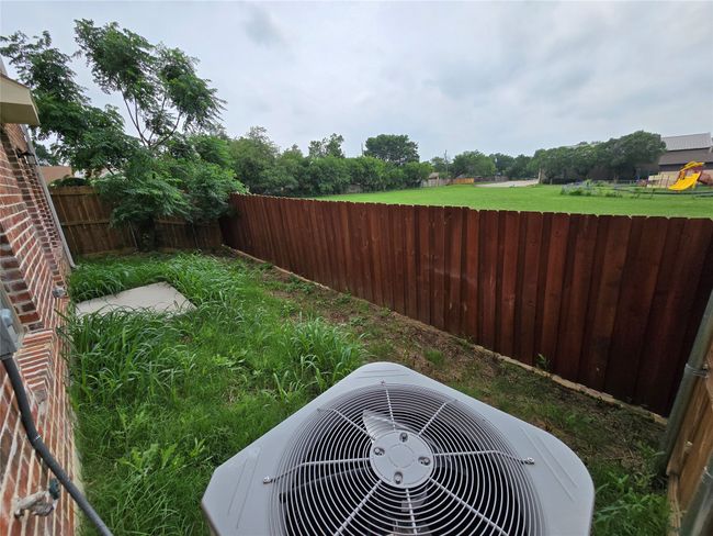 Fenced backyard with central AC | Image 12