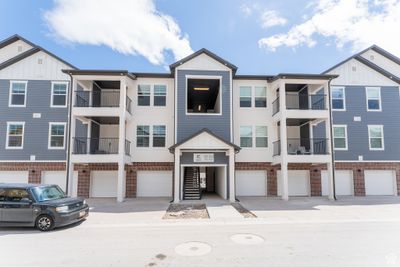 View of front of home featuring a balcony and a garage | Image 1