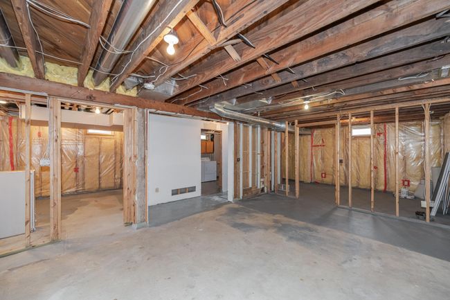 Lower level is waiting to be finished with high ceilings and frame work done | Image 19