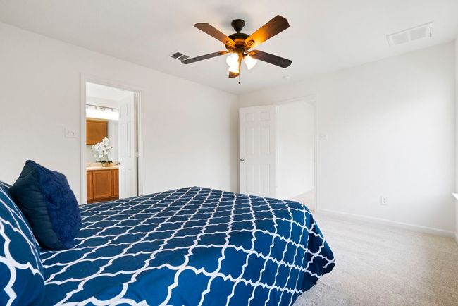 A serene primary bedroom—a tranquil retreat devoid of unnecessary embellishments. | Image 23