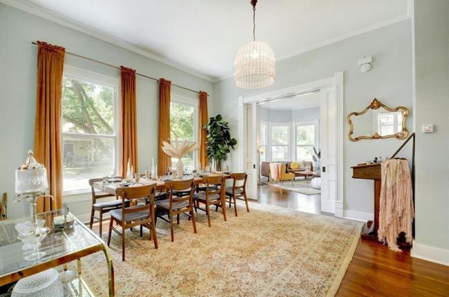 Dining area featuring a chandelier, wood finished floors, and ornamental molding | Image 9