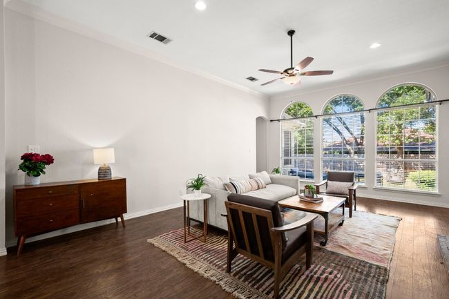 Living area featuring dark wood-type flooring, ornamental molding, ceiling fan, and recessed lighting | Image 10