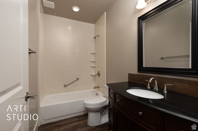 Full bathroom featuring vanity, wood finished floors, shower / bathtub combination, and recessed lighting | Image 30