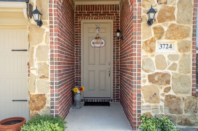 Welcoming entryway with a charming front door and walkway! | Image 4