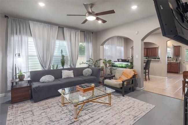 Bright and open living room and dining room with a cozy fireplace! | Image 4
