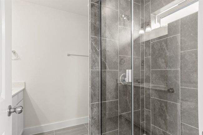 Bathroom featuring vanity, baseboards, and a stall shower | Image 21