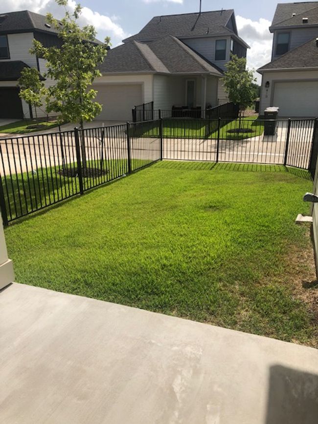 View of fenced backyard and patio | Image 26