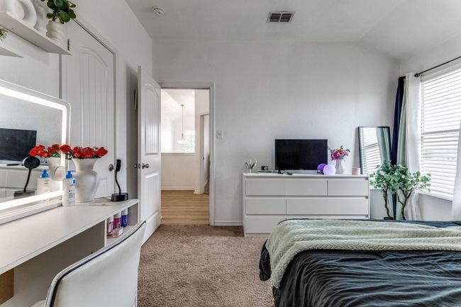 Bedroom with carpet floors, multiple windows, and lofted ceiling | Image 28