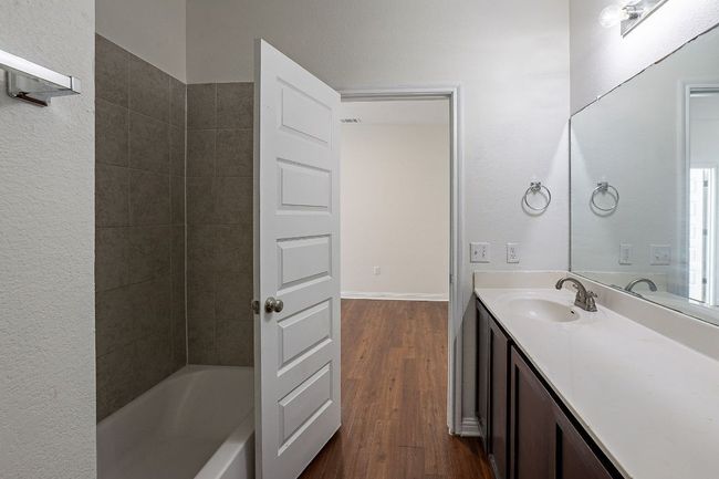 Bathroom with vanity, shower / washtub combination, and wood finished floors | Image 27
