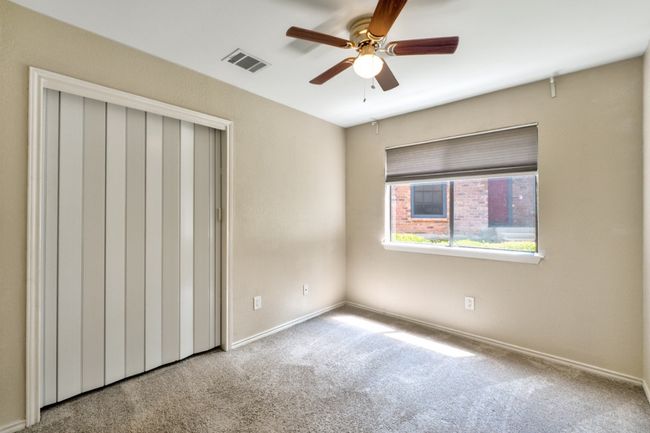 Secondary bedroom #2 features a ceiling fan, abundant natural light and a spacious closet. | Image 20