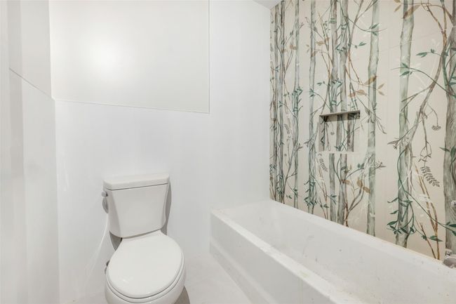 Bathroom with a tub and toilet | Image 41