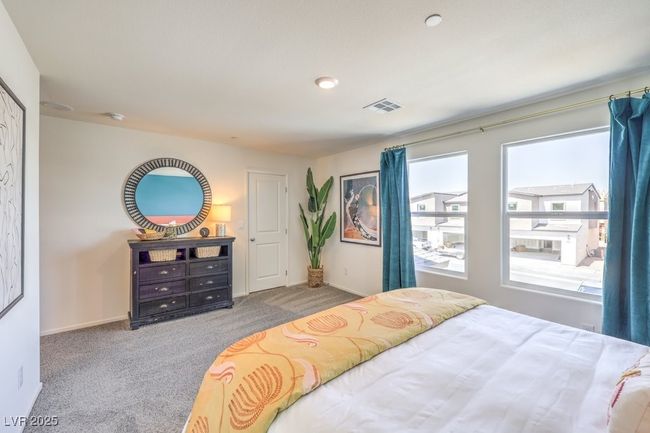 Bedroom featuring visible vents, baseboards, and carpet floors | Image 23