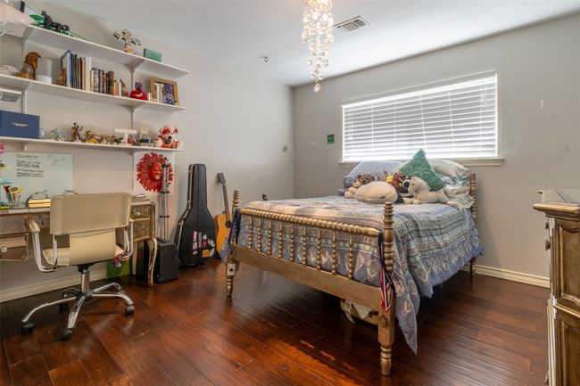 Bedroom featuring hardwood / wood-style flooring, baseboards, and an office area | Image 20